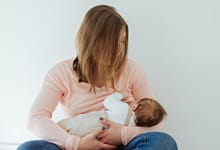 Young Mother breastfeeding newborn baby
