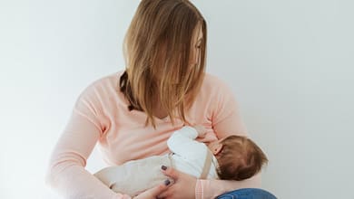 Young Mother breastfeeding newborn baby