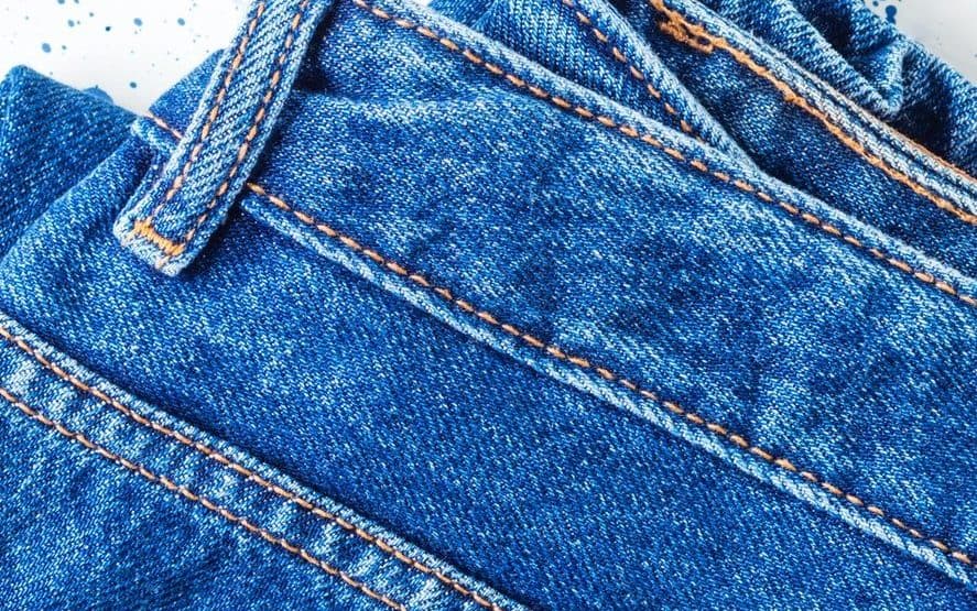 Pair of denim jeans on white background